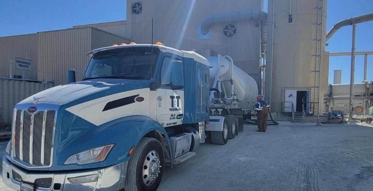 Pneumatic truck trailer loading up at facility