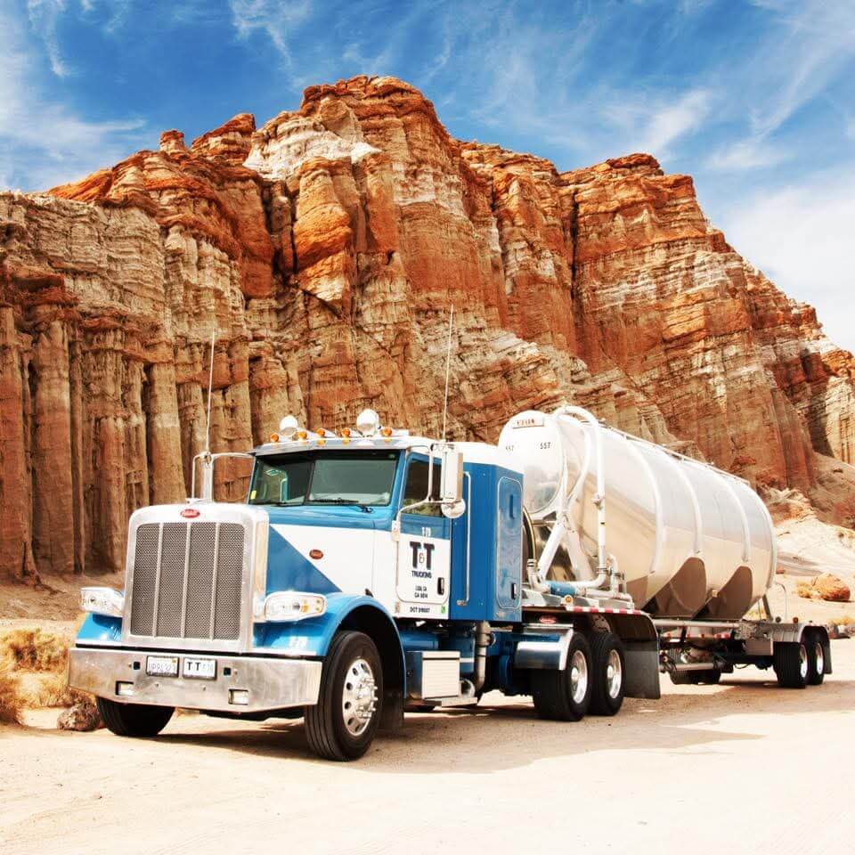 Bulk Transportation truck next to red rock mountain